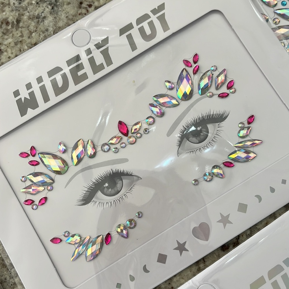 New in package adhesive face jewels for parties , costume , etc . Six designs.